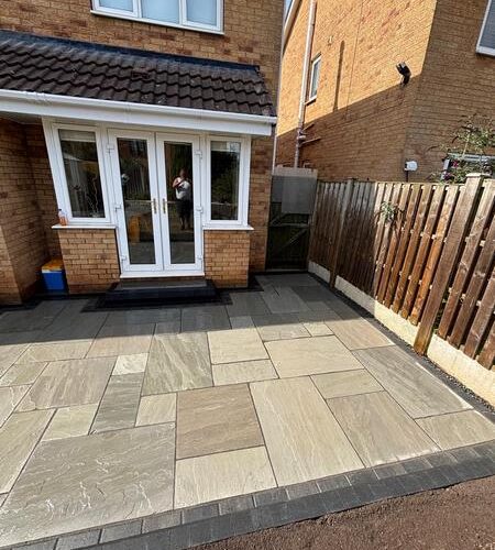 garden transformation natural stone patio charcoal paved border with new steps and channel drainage carlton barnsley 07